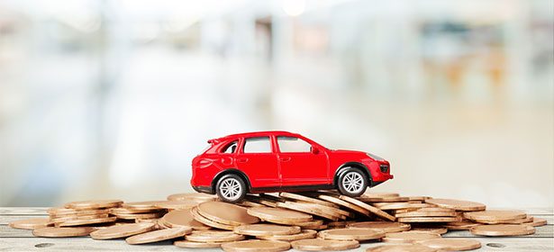 Red Toy Car On Top Of Pile Of Pennies