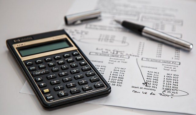 Calculator and Pen on Balance Sheet